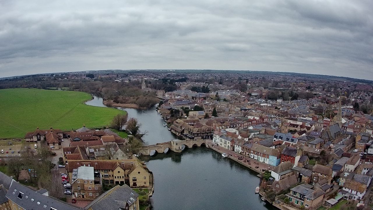 Ruko F11GIM2 Drone Example Image - aerial view of town, old bridge, and river.