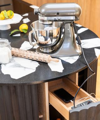 kitchen close up of food mixer plugged into hidden socket in drawer