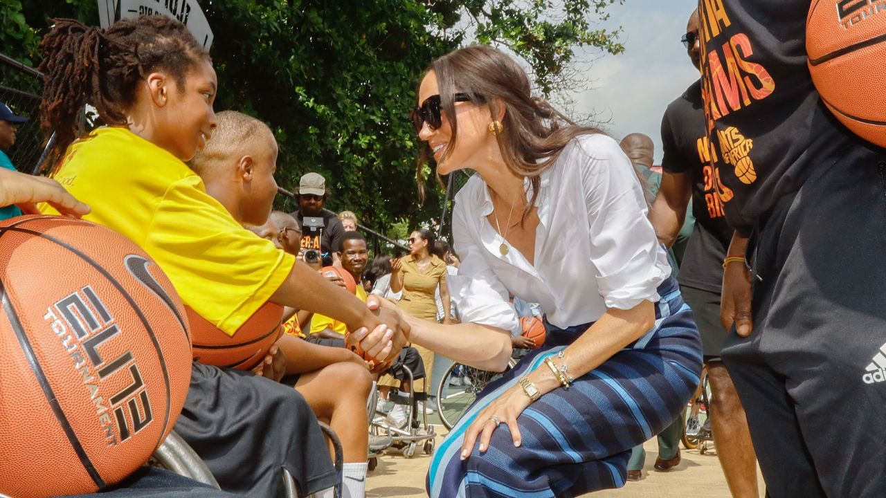 Meghan Markle greets members of the public during her tour of Nigeria