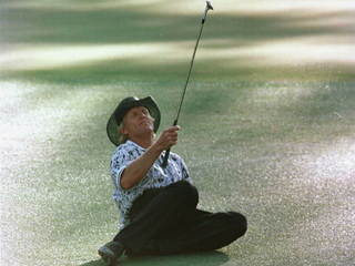Norman's eagle chip slides by on 15 at Augusta in 1996. Moments later he dunked it in the water on 16