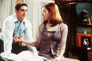 (R, L) Michelle (Alyson Hannigan) hands Jim (Jason Biggs) a condom in American Pie