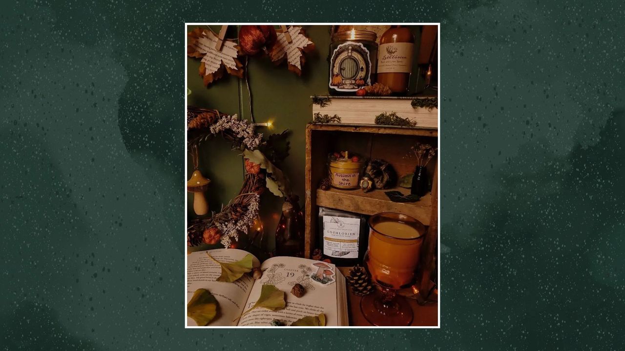 A picture of a desk with dark cottagecore decor on a green background