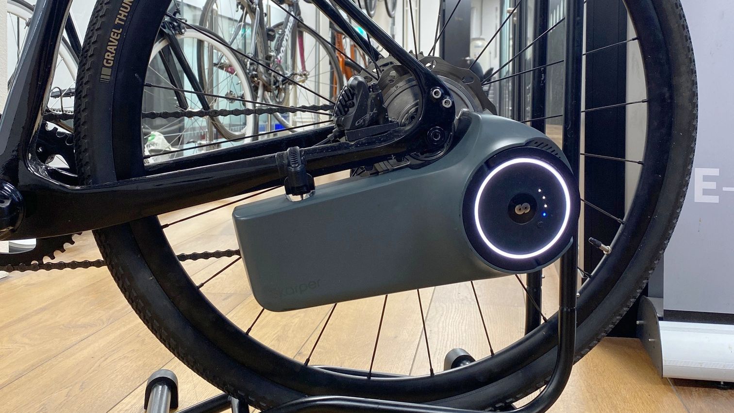 the Skarper e-bike conversion kit mounted on the chainstay of a gravel bike