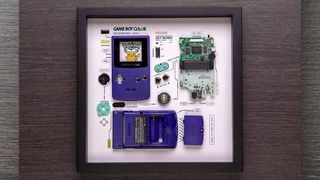 A framed deconstructed Nintendo Game Boy