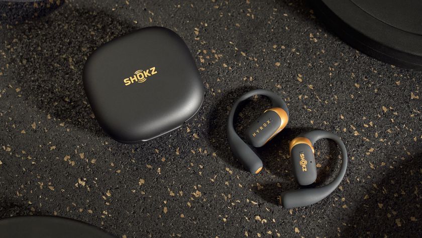 Photo of the Shokz OpenFit 2 Plus HYROX Edition charging case and black-and-gold earbuds.