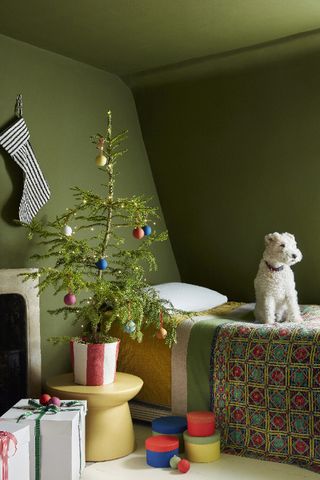Small Christmas tree in green bedroom by Little Greene