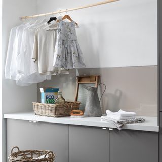 Laundry room with clothes hanging on rail