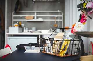 A home office setup with black wire stationery basket