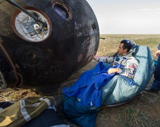 Expedition 32 NASA Flight Engineer signs the side of his Soyuz TMA-04M spacecraft shortly after he landed with his crew mates Expedition 32 Commander Gennady Padalka and Flight Engineer Sergei Revin of Russia in a remote area near the town of Arkalyk, Kazakhstan, on Monday, Sept. 17, 2012. Acaba, Padalka and Revin returned from five months onboard the International Space Station where they served as members of the Expedition 31 and 32 crews.