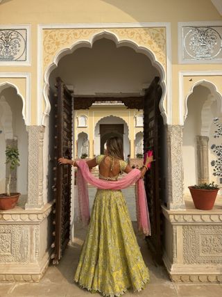 @arentyoueshita wears a lime and pink Indian wedding guest outfit