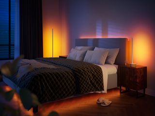 a photo of the Philips Hue Signe gradient lamp in oak in a bedroom