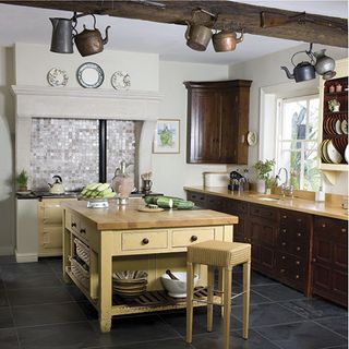 kitchen area with dark slate flooring and wooden table with stool