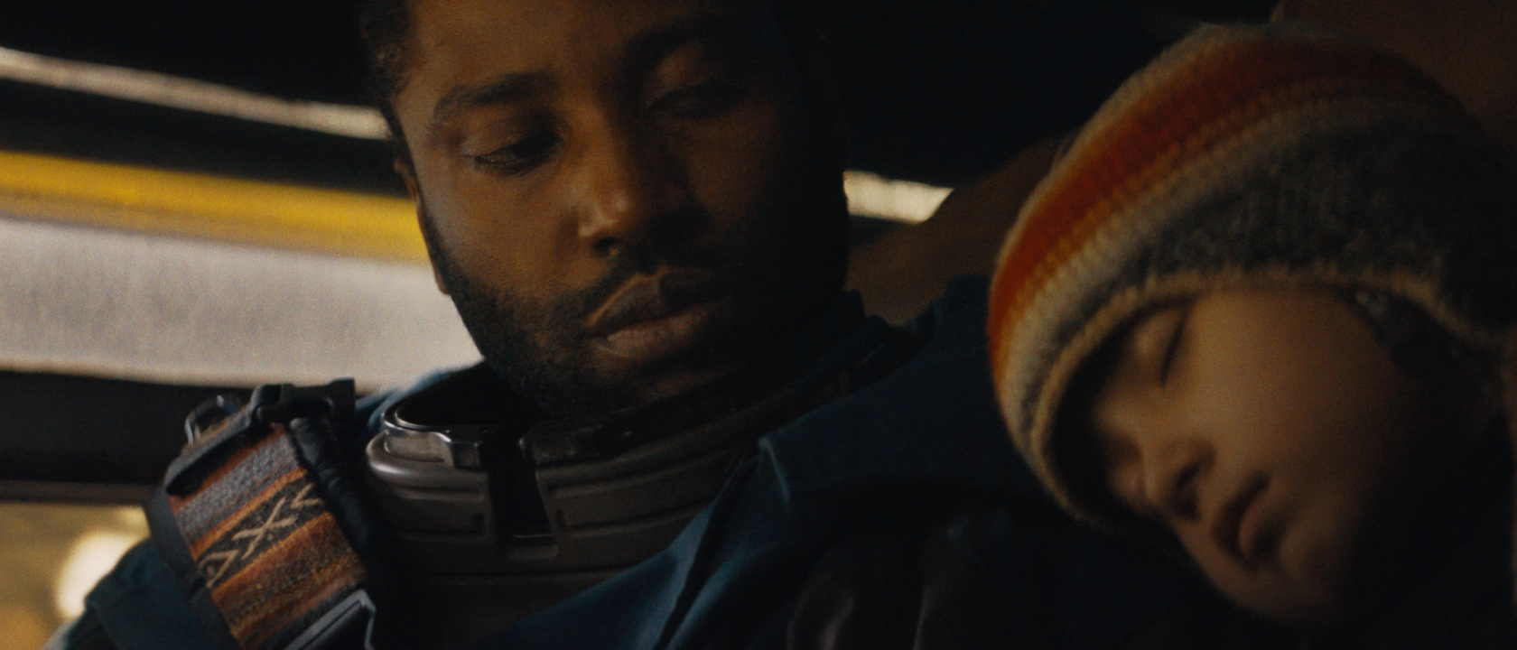 John David Washington watches over a sleeping Madeleine Yuna Voyles in The Creator.