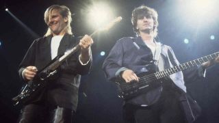 Rush’s Alex Lifeson and Geddy Lee performing onstage in 1986