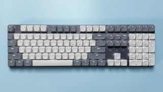 The Satechi SM3 mechanical keyboard against a blue background.