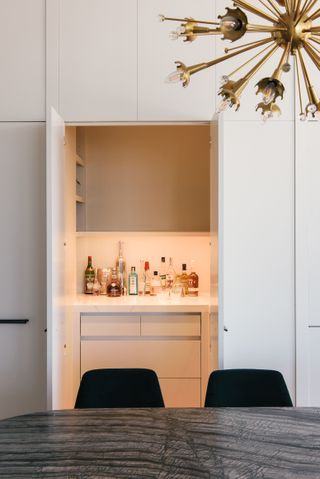 A dining room with a hidden storage pantry