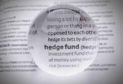 magnifying glass hovering over phrase "hedge fund" in dictionary
