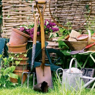 Garden tools including hoe, spade, pots and watering can