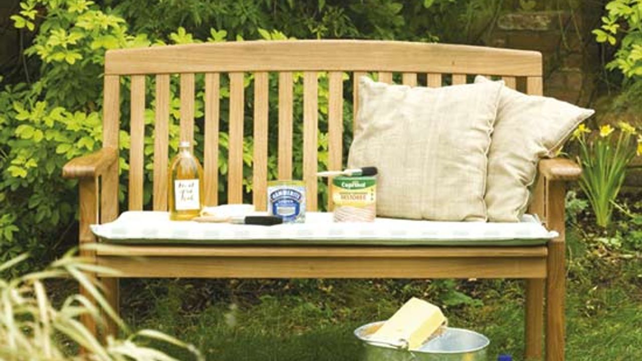 garden area with wooden bench and cushion