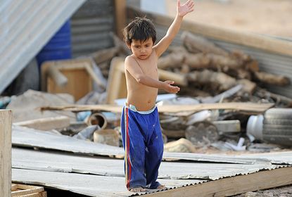 The child of a stateless family plays outside his makeshift home in an impoverished neighbourhood, east of the Saudi capital 
