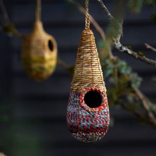 A Recycled Sari + Seagrass Bird House in a Raindrop shape
