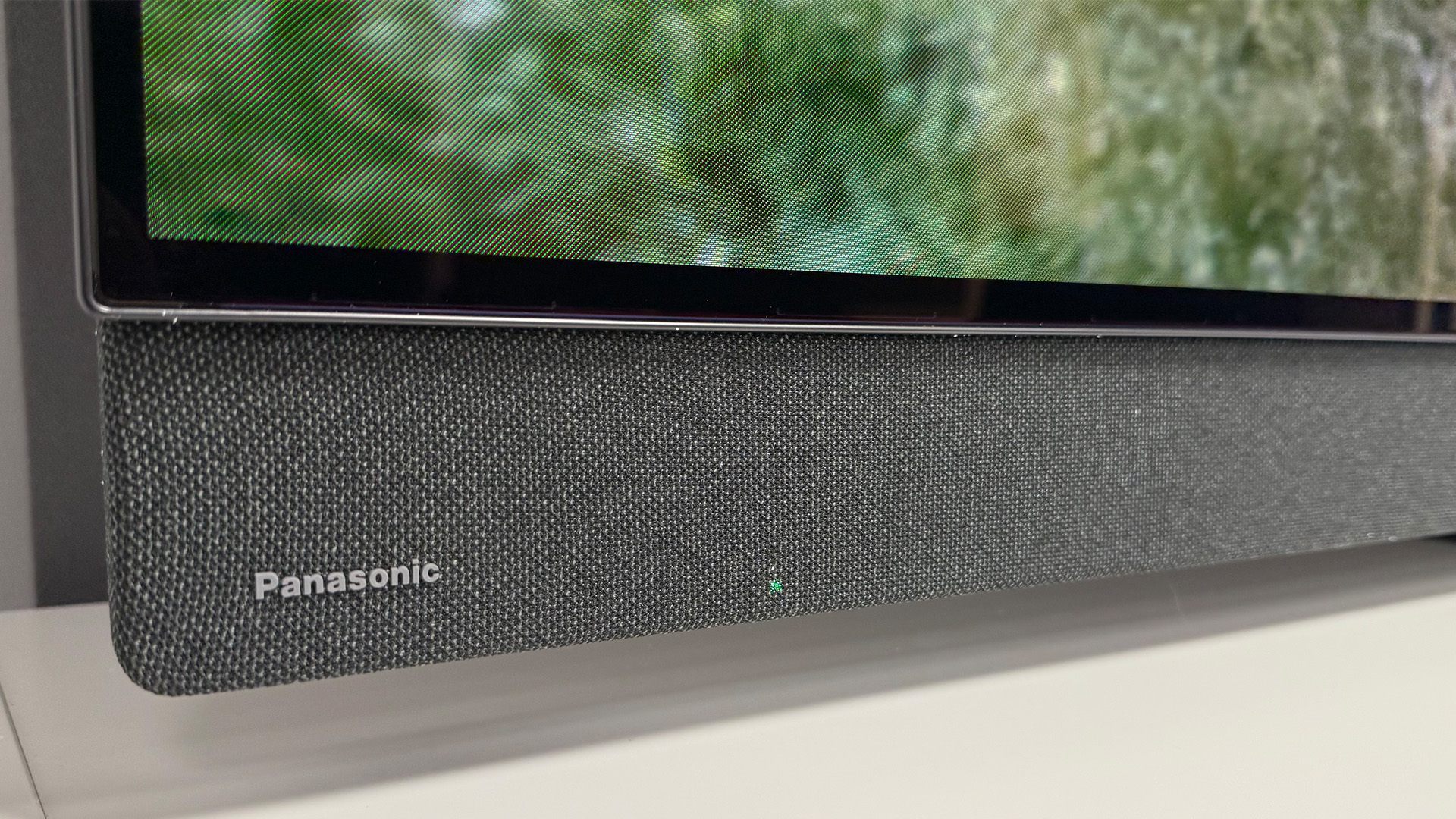 Panasonic Z95B 65-inch OLED TV detail of bottom of TV and integral soundbar with Panasonic logo