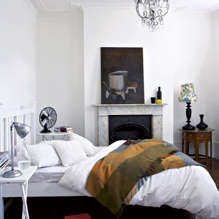 bedroom with white walls and bed with pillows