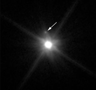 A moon is spotted around the dwarf planet Makemake in this Hubble Space Telescope Image from April 2015.