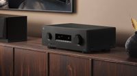 A black Yamaha RX300A on a wooden cabinet.