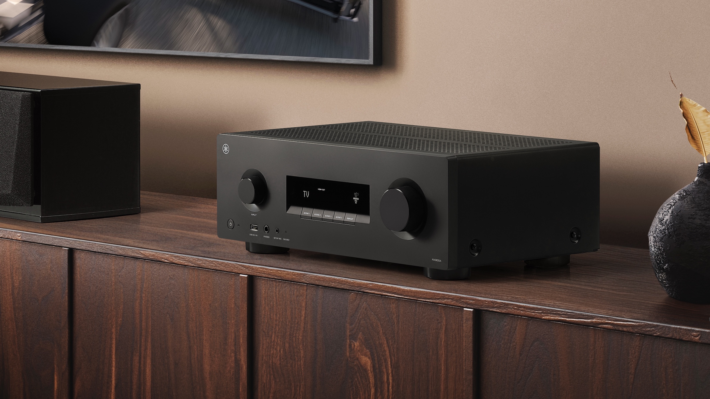 A black Yamaha RX300A on a wooden cabinet.