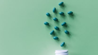 Green l-theanine tablets on green background