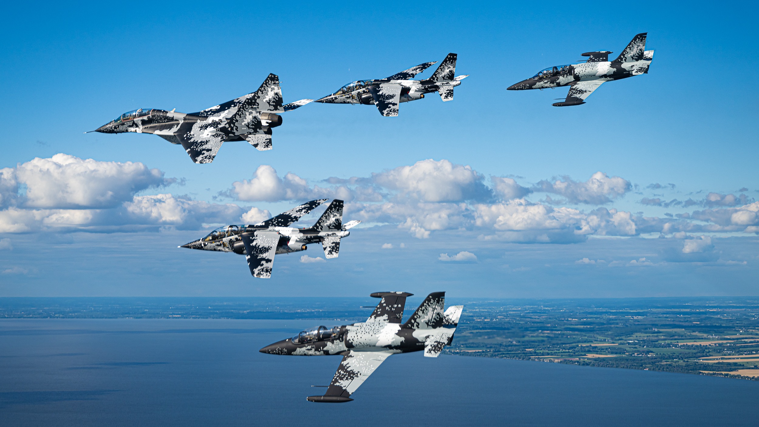 five Mikoyan MiG-29 aircraft fly in a triangle/arrow formation.