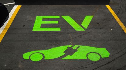 Parking space with electric vehicle painted in green