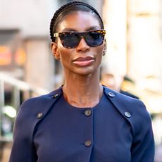 Michaela Coel tapped into the suit skirt trend wiht a deconstructed navy blue two-piece