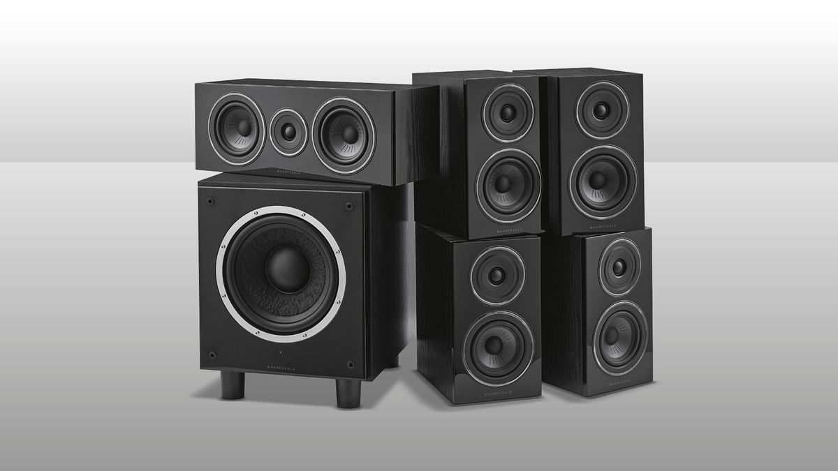 A picture of the Wharfedale Diamond 12.1 HCP speaker system. It shows a square subwoofer on the left with another speaker positioned on top, with the other four speakers arranged to the right. They are all black on a grey background.