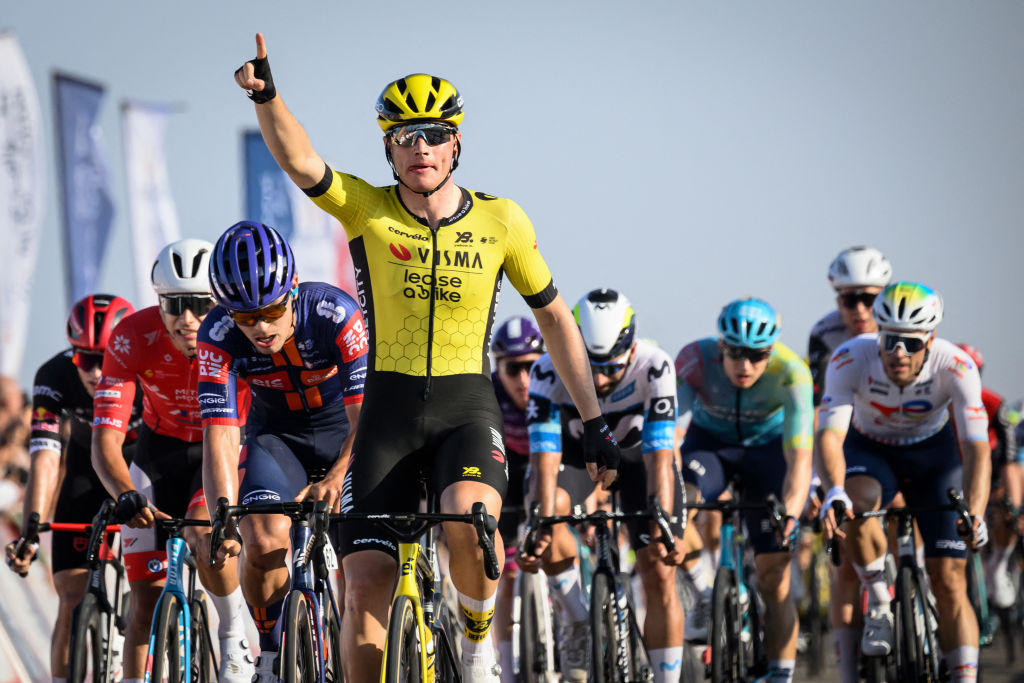 Visma-Lease a Bike team's Netherland rider Olav Kooij celebrates after crossing the finish line to win the first stage of the Tour of Oman cycling race from Bushar to Bimmah Sinkhole, eastern Muscat Governorate, on February 8, 2025. (Photo by Loic VENANCE / AFP)