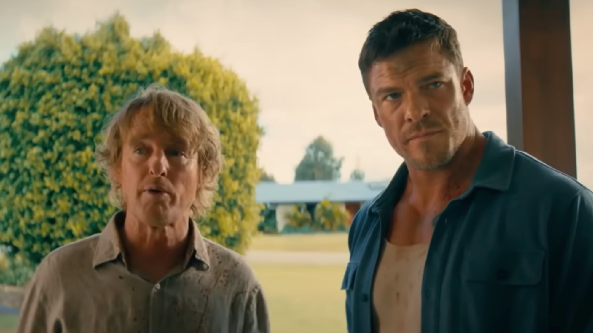 Owen Wilson on the left, standing with Alan Ritchson in Runner
