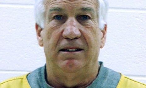 Former Penn State assistant football coach Jerry Sandusky was arrested on new charges Wednesday, including that he sexually abused a young boy who frequently spent the night in Sandusky&amp;#039;s bas