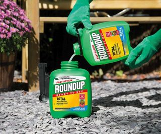 Hands pouring a bottle of Fast Action Ready To Use Weedkiller Pump 'N' Go 5 Litres