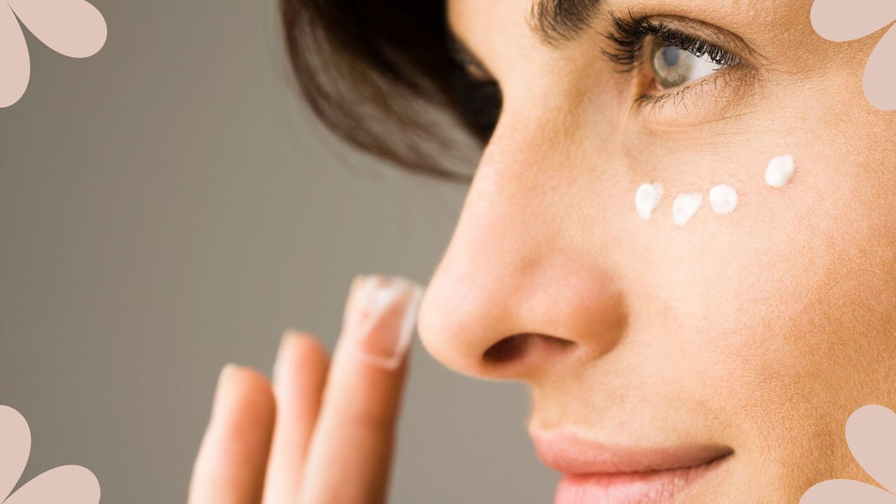 A close-in shot of a woman dotting on eye cream, to illustrate the question &#039;is eye cream necessary?&#039;