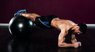 Gym ball decline plank