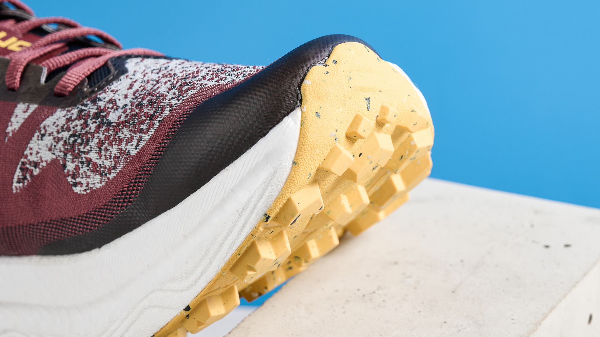 the icebug j&amp;auml;rv rb9x trail running shoes in cherry and banana photographed against the tom's guide blue background