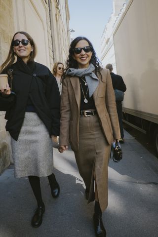 A guest at Paris fashion week wearing a brown plaid blazer and brown skirt