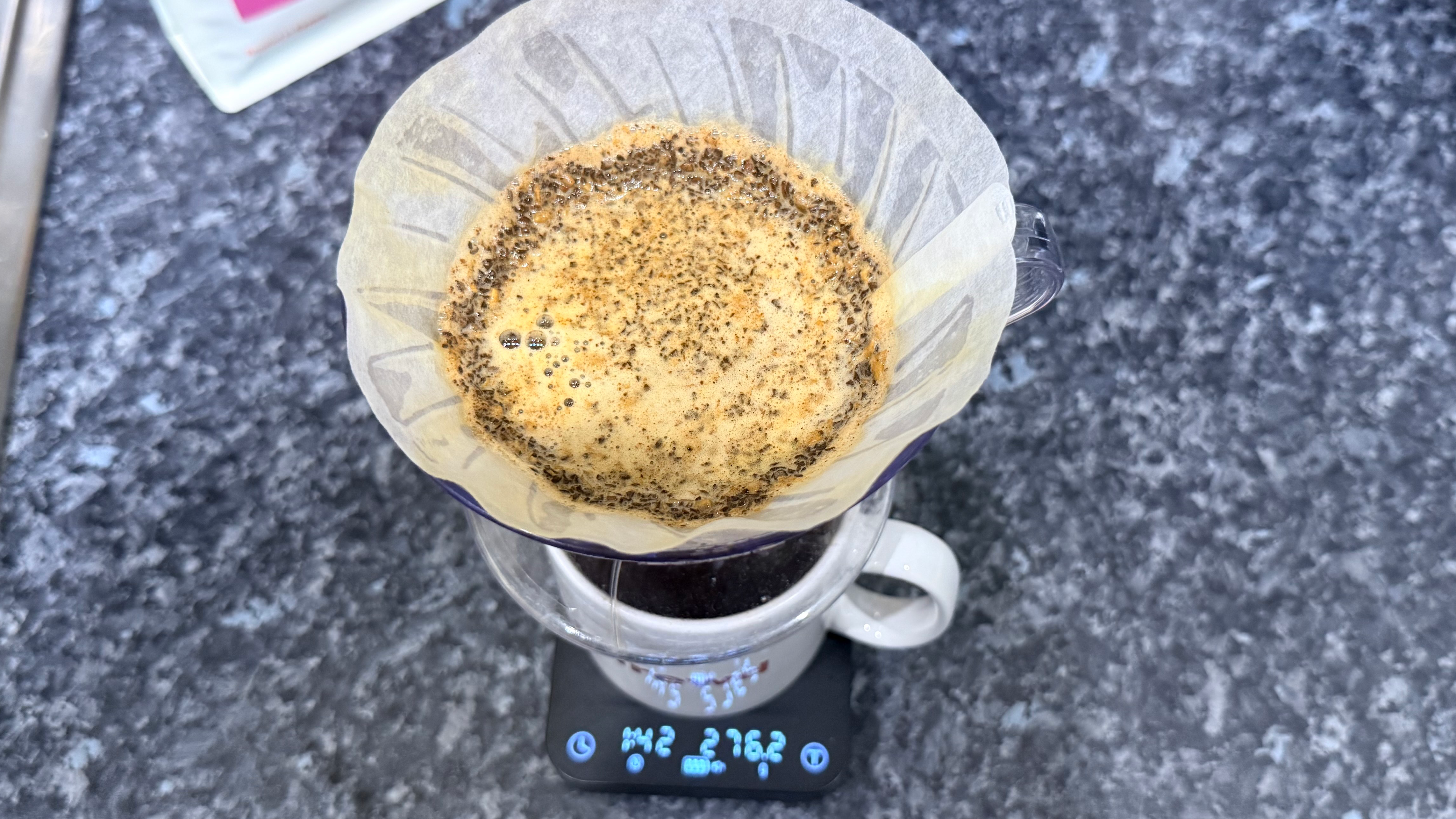a photo of pour-over coffee made on the hario v60 dripper photographed with the wacaco exagram pro coffee scale