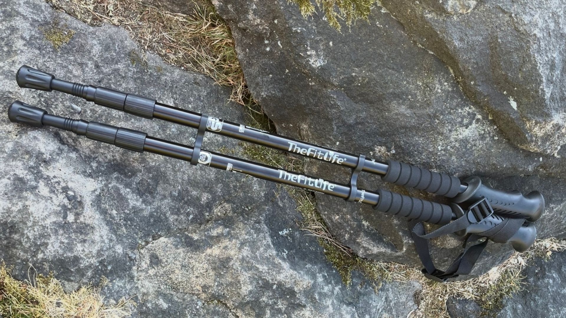 FitLife Hiking Walking Trekking Poles used by Susan Griffin on a walk, with hand holding handle and poles resting against rocks and product shot