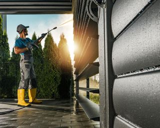 Man washing side of house