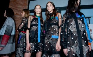 five female models wearing clothing with geometric prints