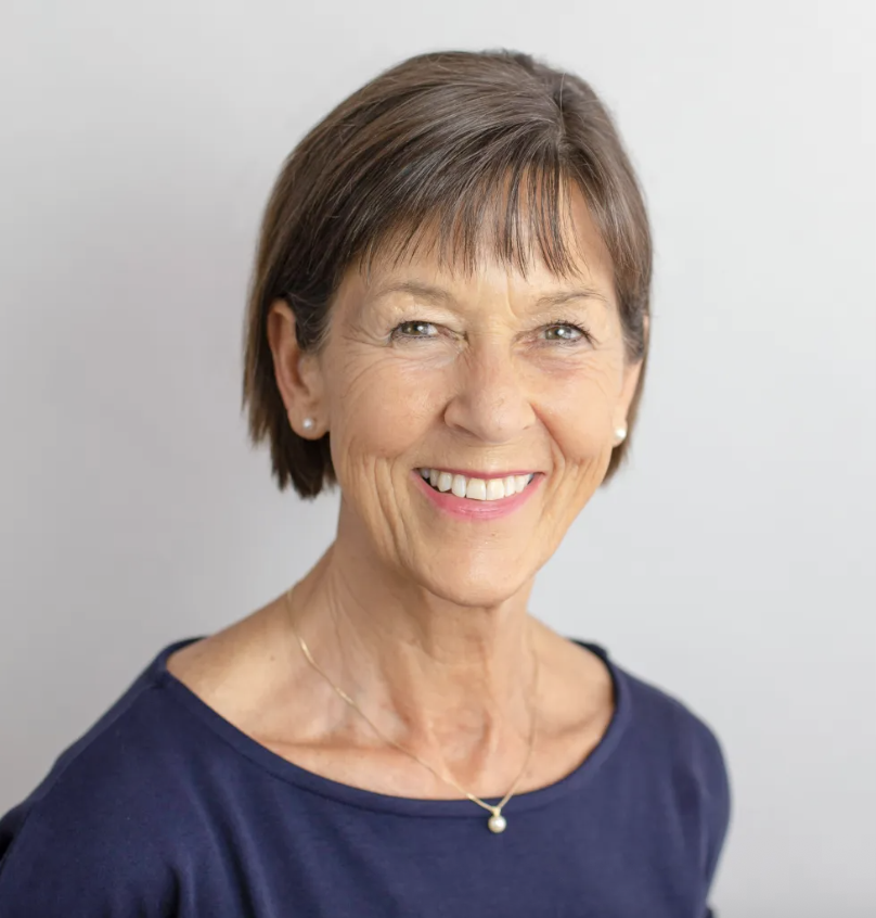a white woman in a navy shirt with short gray hair