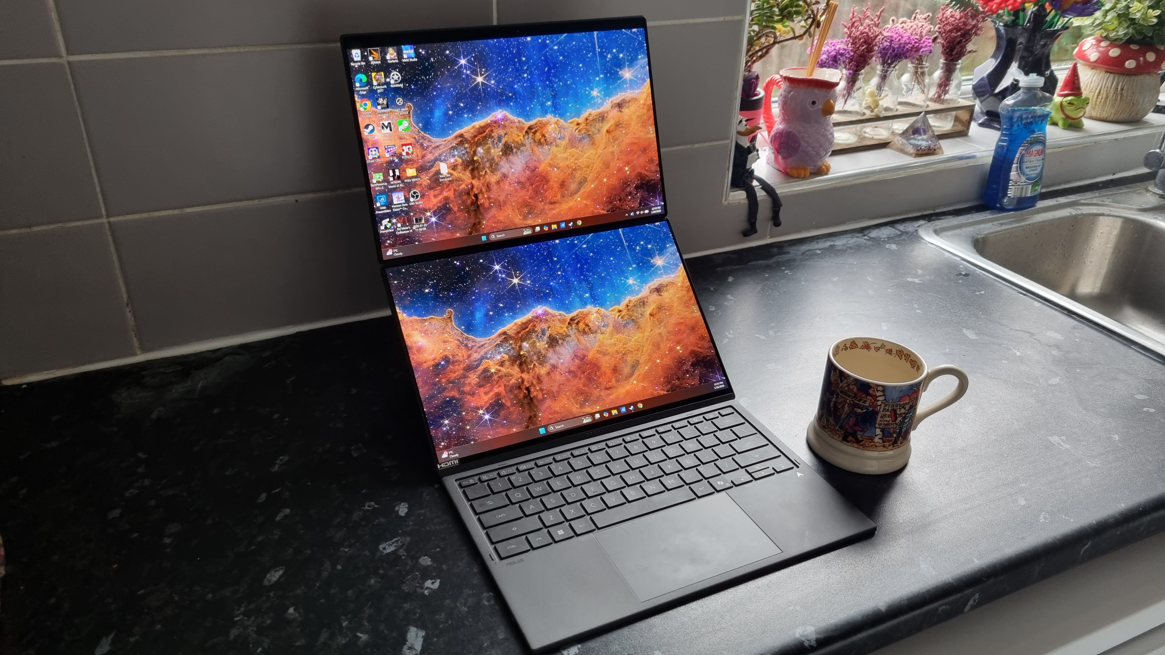 An Asus Zenbook Duo laptop with both of its OLED screens deployed