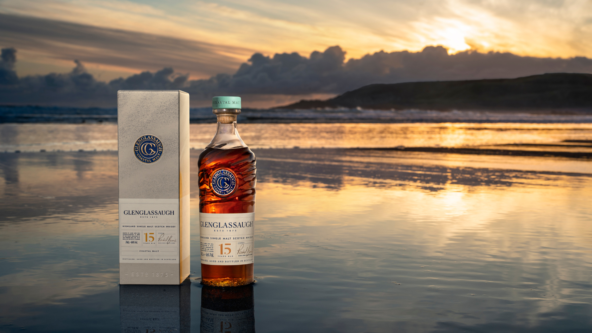 an image of the 15 Year Old whisky bottle and box on a beach shore in the highlands